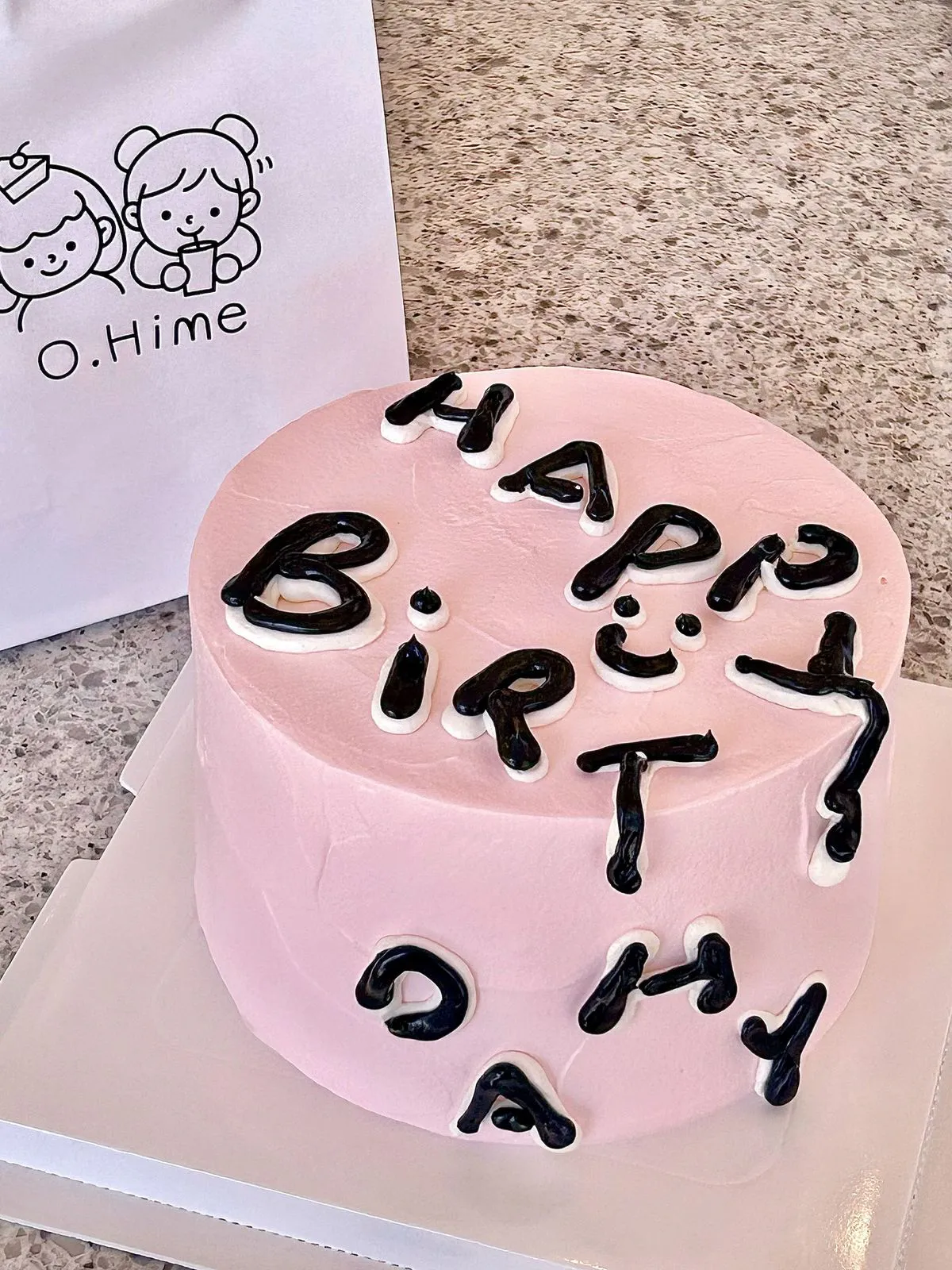 Minimal pink cream cake with black handwritten birthday lettering at O.Hime Cake, a Bakery in Waterloo