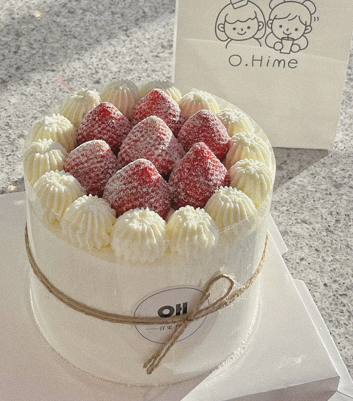 White cream strawberry cake wrapped with twine rope and powdered sugar at O.Hime Cake, a Bakery in Waterloo